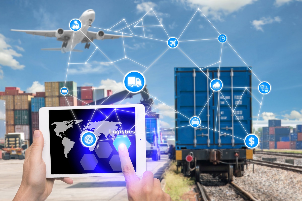 Hand holding tablet is pressing button Logistics connection technology interface global partner connection for logistic import export background. Business logistics concept , internet of things