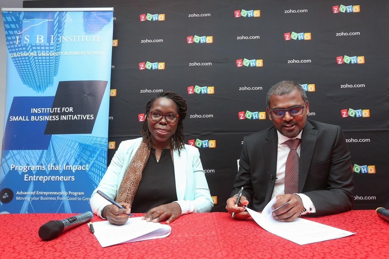 Maryanne Akoth, Director for Programs, Institute for Small Business Initiatives (L) and Veerakumar Natarajan, Country Head - Kenya, Zoho Corp.(R) signing the MoU