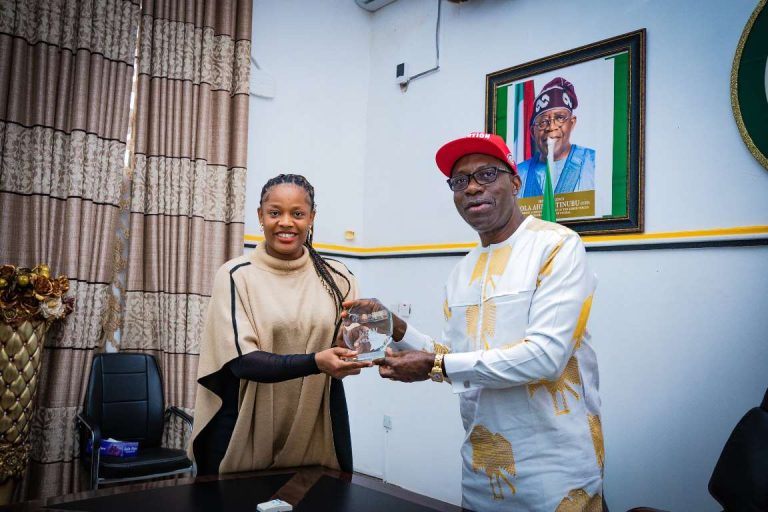 Professor Charles Chukwuma Soludo, the Governor of Anambra State, receiving the induction plaque presented by Chinwe Okoli, the Special Adviser to the Governor on Innovation and Business Incubation who serves as the CEO of Solution Innovation District.