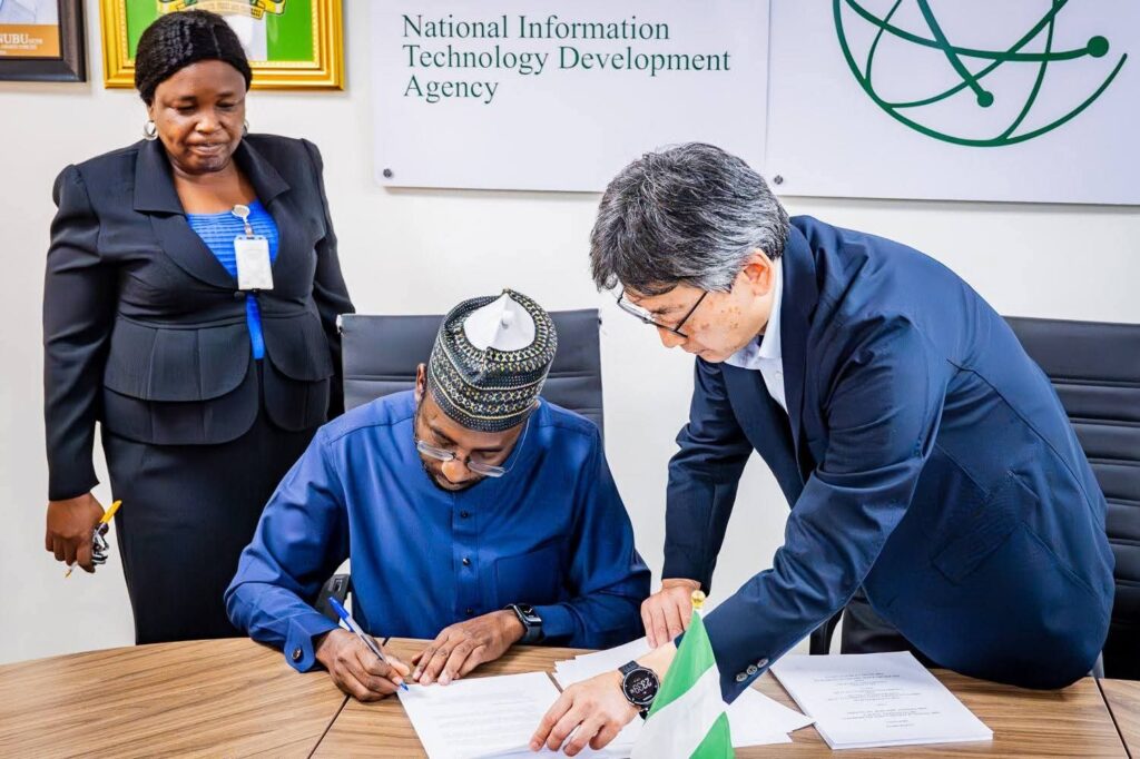 Nigeria, JICA to Unveil $11.2M Innovation Hub to Boost Startup Ecosystem 2 Photo of the DG NITDA, Kashifu Inuwa CCIE (middle), signing the agreement document to commence the project on the establishment of the Startup Hub in Abuja